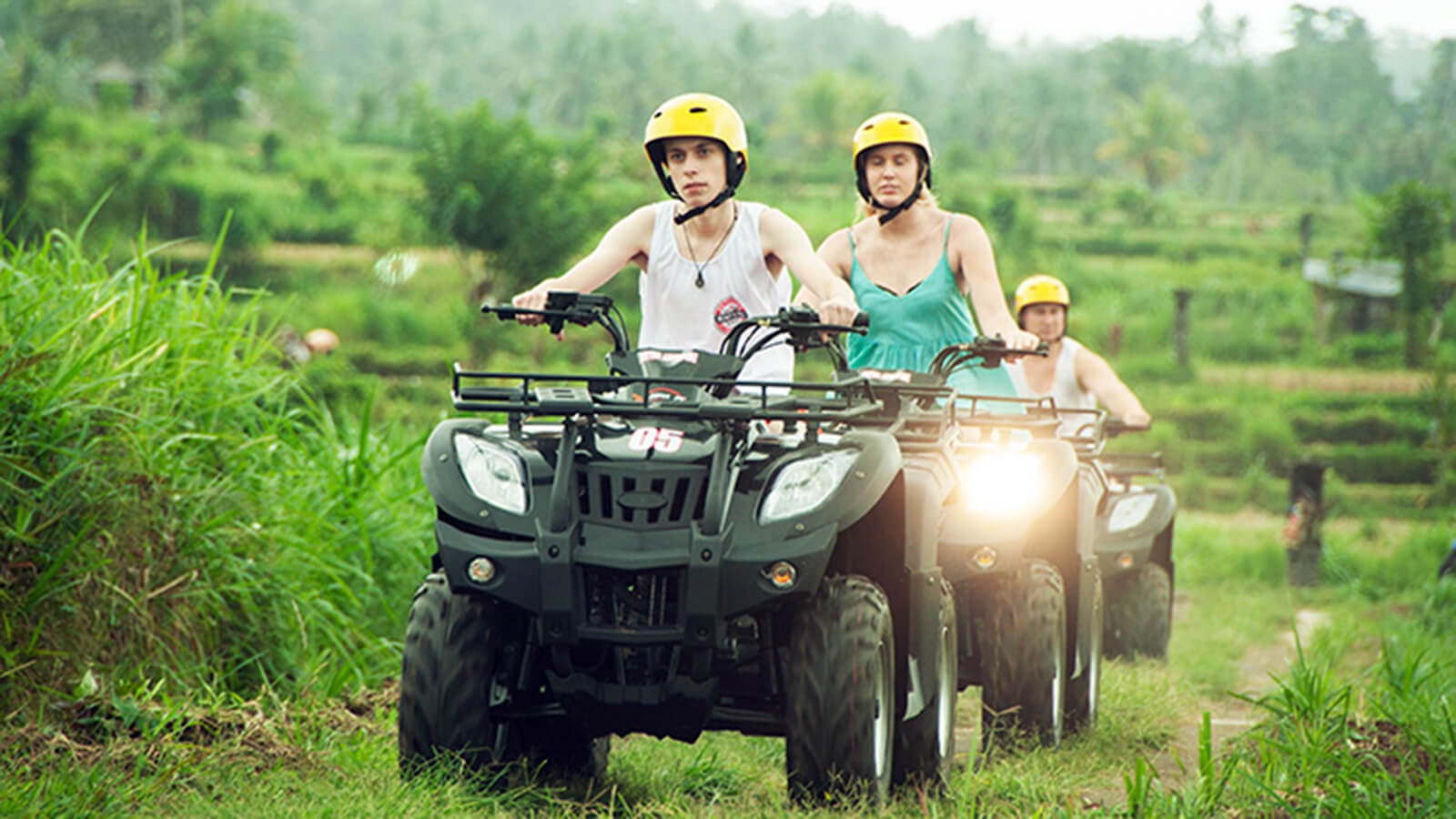 Group of riders on ATV quad bikes in the rice fields of Ubud, Bali