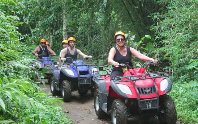 Riders on ATV quad bikes on a jungle track in Ubud, Bali