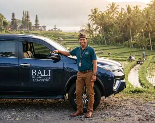 Taxi Airport Bali driver beside a private car near rice fields