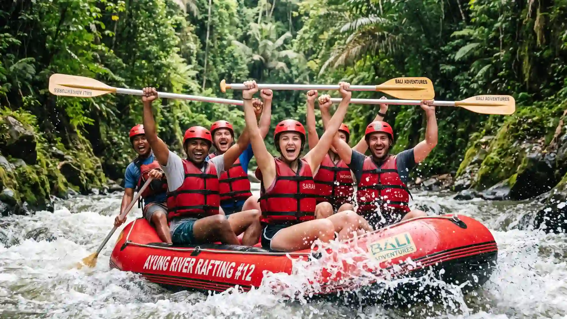 Rafting group raising their paddles on the river in Ubud, Bali