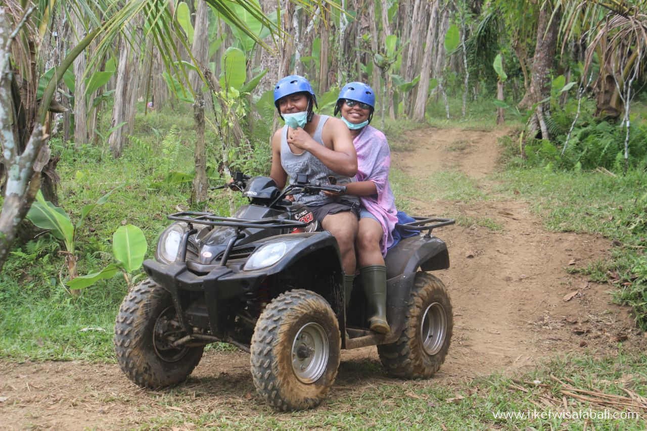 Two riders on a tandem ATV quad bike in Ubud, Bali